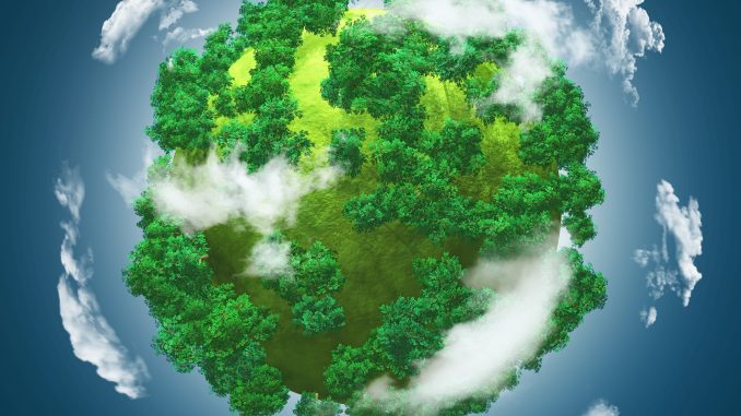 3D grassy globe with trees against a blue cloudy sky zdjęcie ilustracyjne